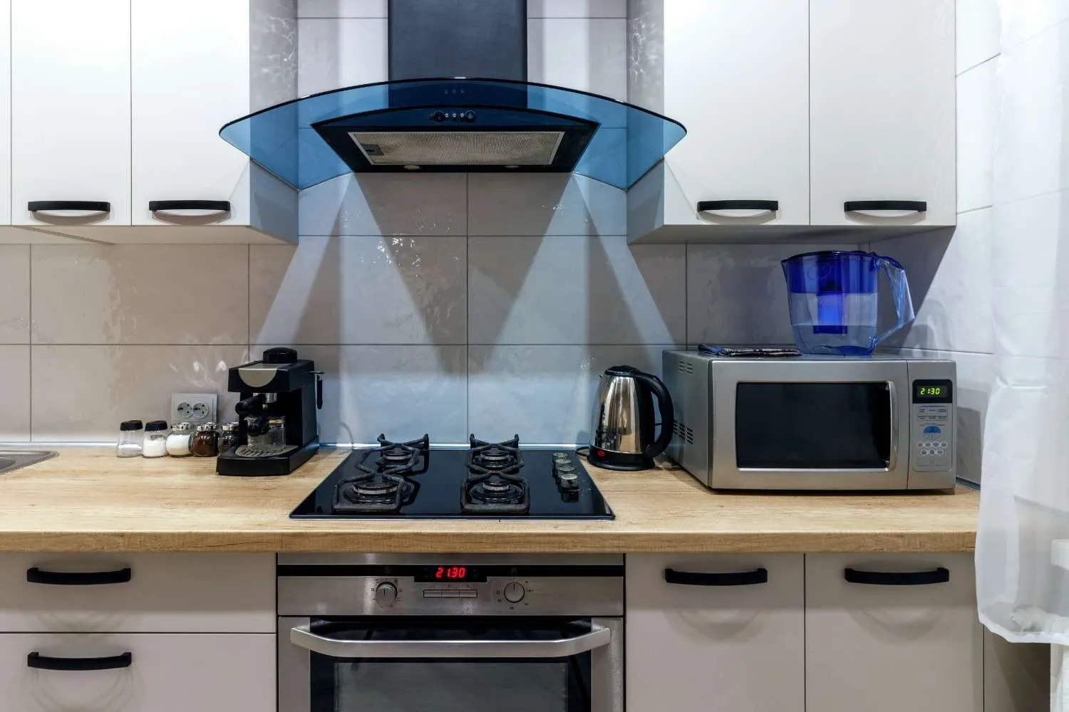 Gas cooktop, wall oven and microwave under a range hood